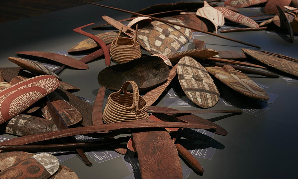 Indigenous objects on display like textiles such as baskets and wooden tools at the National Museum of Victoria, Melbourne, Australia