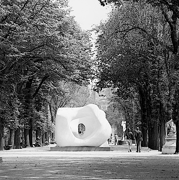 Black-and-white photograph of a Henry Moore sculpture, "Large Two Forms," in the Jardin des Tuileries, Paris