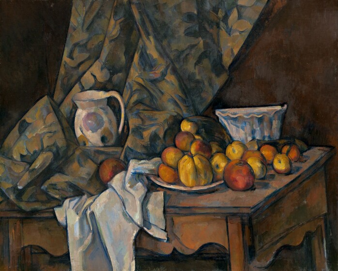 About a dozen rust-orange and golden-yellow apples and peaches are arranged on a white plate next to white and floral patterned cloths nestled around a white pitcher and bowl, all on a wood tabletop that tilts towards us in this nearly square still life painting. A curtain patterned with royal blue, olive green, and beige falls along or near the back wall of the room and rests on the table to our left. The white pitcher painted loosely with the suggestion of harvest gold and pale lilac-colored flowers sits amid the pooling folds of the curtain to our left. The white tablecloth is bunched under and next to it to our right, at the middle of the composition. The fruit is arranged on and around a white plate next to the tablecloth. A tall bowl with fluted sides and a ruffled edge sits behind the fruit, near the right edge of the table. The curving skirt of the table reaches nearly to the bottom edge of the canvas. All the objects in the painting are outlined with dark blue paint and the shadows are painted with patches of spruce and cobalt blue.