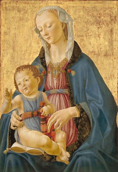 Against a gold background, a blond woman is shown from the lap up, facing us as she holds and looks down at a plump baby sitting on a gold and white pillow on her lap in this vertical painting. Both people have pale, peachy skin, and faint halos encircle their heads. The child sits with his body angled to our right, toward his mother, but he turns to look off to our left with pale green eyes. He holds his right hand, on our left, up with his thumb and first two fingers raised. He has short, light brown hair, rounded cheeks, a delicate nose and lips, and chubby legs. He wears a light blue smock edged in gold, with gold filigree at the collar. The garment is belted with a twist of fabric patterned in bands of red, black, and gold. Under the smock he wears a half-sleeved, transparent undershirt. The woman steadies the baby with her long, delicate hands. She wears a sky-blue robe edged with gold, Arabic-like script. The lining, in a black and brown floral pattern, is visible where the edges of her robe turn back over her wrists and around her neck. Belted across the chest in a twist of blue and gold fabric, her dusky-pink dress is lined at the neck with a gold band with red and blue gems, with a brooch of pearls and rock crystal at the center. Her headdress is a sheer, white cloth bordered with a gold stripe, rolled atop her head and falling to her shoulders, where it is tucked into her robe. Some areas of the gold background have worn away to show the red layer beneath.