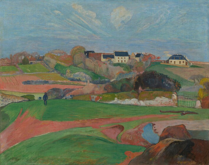 We look across rolling, bright green pastures and honey-brown farmland to a cluster of buildings nestled beyond a copse of trees, along the horizon in this horizontal, stylized landscape painting. The scene is painted with mostly flat areas of color. Closest to us, low, vibrant green pastures are bisected by a narrow, gingerbread-brown path. The path meanders from the lower left corner of the composition to a metal gate, near the right edge of the painting. A short distance from us to our left, a man wearing navy-blue pants, shirt, and hat walks along the top of a hill, hands in pockets. Two black and white cows and one brown and white cow graze nearby. In the distance, the copse of trees is painted with pockets of pumpkin orange, lavender purple, sky blue, and spring and muted sage green. Beyond the trees, a white, square, two-story house with a spruce-blue roof sits within the grouping of buildings. Another white building with a blue roof stands a bit to our right. Wisps of white clouds dot a vivid blue sky, which is tinted with pale pink and lilac purple near the horizon. The artist signed and dated the work in harvest yellow against a mound of dark brown rocks in the lower right corner: “P. Gauguin 90.”